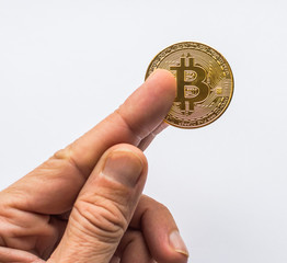 Hand holding golden Bitcoin virtual money