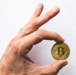 Fototapeta na wymiar Hand holding golden Bitcoin virtual money