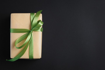 gift on a dark background, top view on a gift box