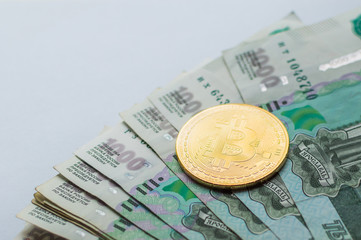 Bitcoin crypto currency coin on Russia Ruble banknotes