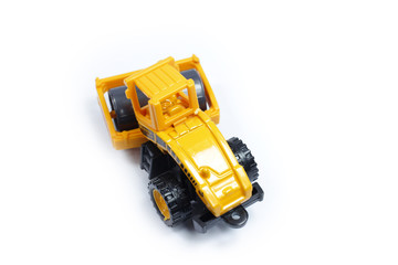 Fototapeta premium Toy construction vehicles Excavator industrial machine doing construction new road earthworks on white background