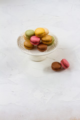 Macaroons isolated. Blue, rose and baige colors. White plate, white background.
