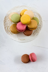 Macaroons isolated. Blue, rose and baige colors. White plate, white background.