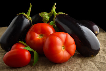Summer vegetables: fresh juicy red tomatoes and eggplants
