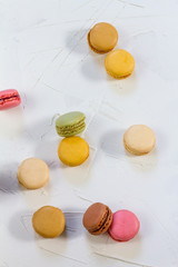 Macaroons isolated. Blue, rose and baige colors. White plate, white background.