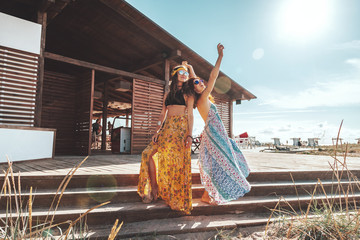Boho girls walking on the beach © Alena Ozerova