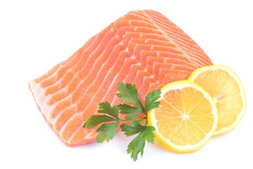 Salmon steak with lemon on white background