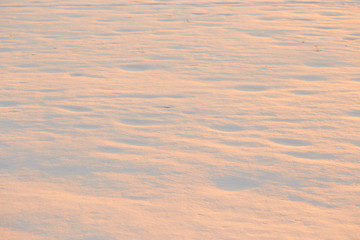 light and shadow on the snow in the golden hour. background.