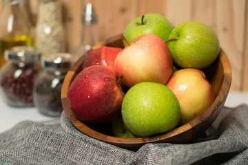 Apple placed in a wooden Cup in the kitchen.
