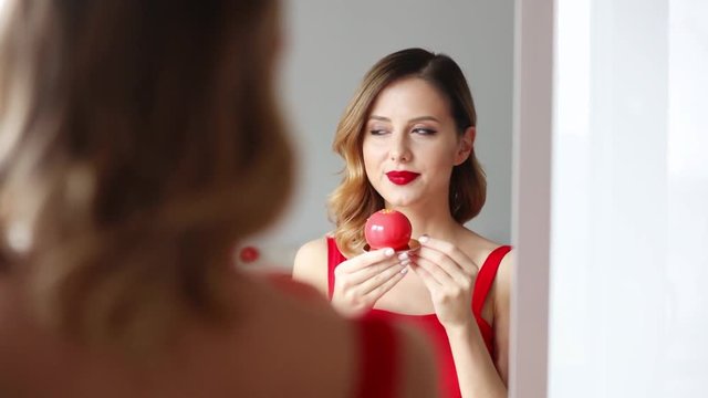 Young redhead woman eating a cake
