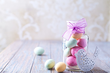 Colorful Chocolate Easter Eggs in a Jar. Copy space. Easter template