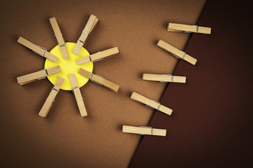 abstract sun with wooden pegs on clothes