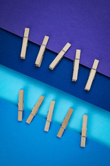 wooden pins attached to blue and purple paper