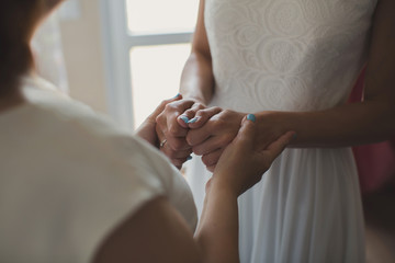 Mom holds her daughter's hand.