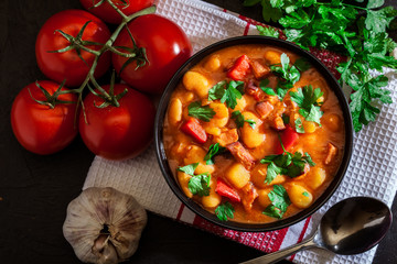 White bean soup with potatoes, tomatoes, paprika, and bacon