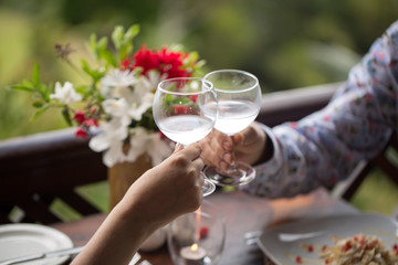 bride and groom holding beautifully decorated wedding glasses