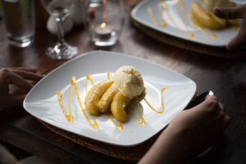 Fried banana and ice cream on a plate.