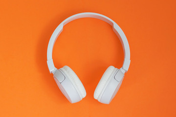 Headphone. Music concept. Flat lay: headphones on orange background. Top view. Trendy colorful...