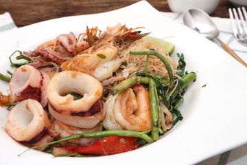 noddle tom yum seafood in white plate