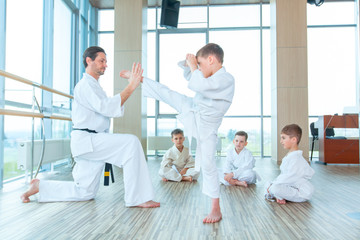 Obraz premium young, beautiful, successful multi ethical kids in karate position