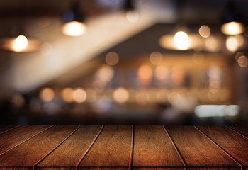 Wooden board empty table  cafe, coffee shop, bar blurred background can be used for display or montage your products and Mock up