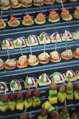 Canapes of cheese vegetables meat and seafood. buffet table