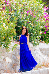 Young beautiful girl in blue dress on he street of Hydra island. Summertime vacation concept
