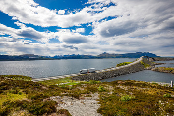 Truck rushes down the highway in the background Atlantic Ocean Road Norway.