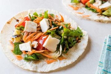 Fototapeta na wymiar Homemade Vegetarian Tostadas with Salad, Cheese and Grated Carrot Slices