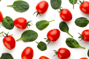 Spinach and tomato pattern background on white. Top view