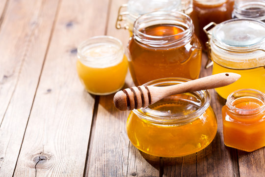 various types of honey in glass jars