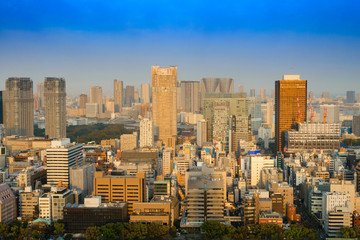 Fototapeta premium cityscape of tokyo city skyline in Aerial view with skyscraper, modern business office building with blue sky background in Tokyo metropolis city, Japan.