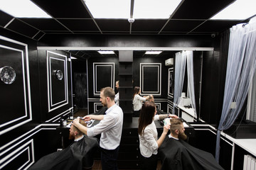 Obraz premium Work in a barbershop. Two masters at work.