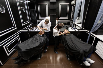 Work in a barbershop. Two masters at work.