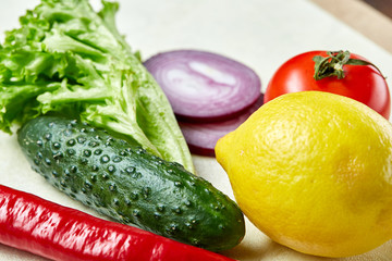 Fresh vegetables still life. Veges lined up on a white background, top view, close-up, selective focus, copy space.