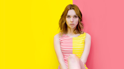 fashion portrait of a girl dress striped two-tone. about a half-and-half strip in the middle. the...