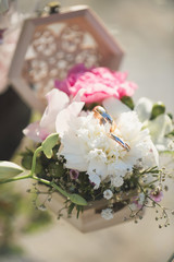 Wedding rings in a box with flowers