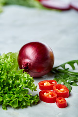 Fresh vegetables still life. Veges lined up on a white background, top view, close-up, selective focus, copy space.