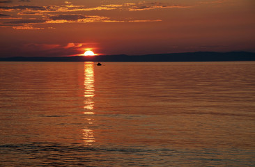 Sanset on Lake Baikal with a boat.
