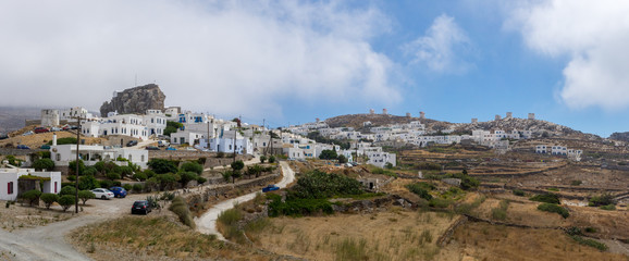 Fototapeta na wymiar A panoramic view of the Chora of Amorgos, the castle on the left and the windmills on the right