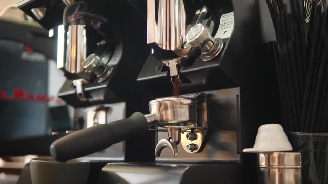 Barista Grinding Coffee Beans in Professional Grinder Machine. 4K, Slowmotion.