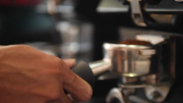Barista Grinding Coffee Beans in Professional Grinder Machine. 4K, Slowmotion.