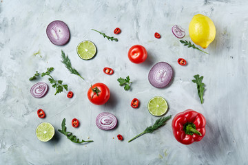 Chopped onion, red hot pepper and spice isolated on white background, top view, close-up, selective focus