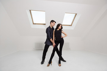 beautiful couple dancing bachata on white background in studio