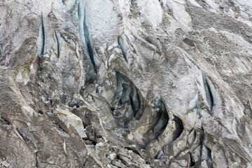 Aerial view of show and ice of Kashkatash Glacier on the west Caucasian mountains in Russia.