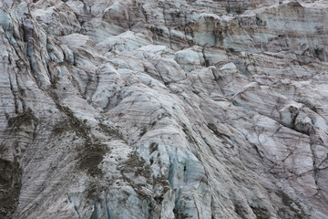 Aerial view of show and ice of Kashkatash Glacier on the west Caucasian mountains in Russia.