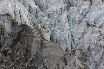Aerial view of show and ice of Kashkatash Glacier on the west Caucasian mountains in Russia.