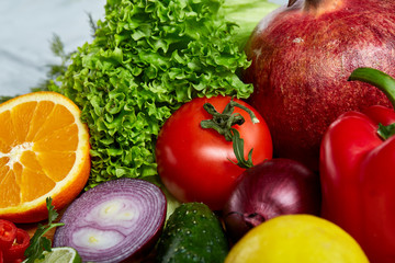Ripe fresh fruits in a wooden plate on a light background, selective focus, close-up, top view