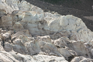 Aerial view of show and ice of Kashkatash Glacier on the west Caucasian mountains in Russia.