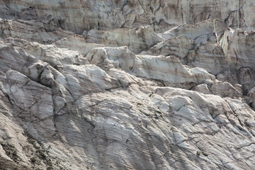Aerial view of show and ice of Kashkatash Glacier on the west Caucasian mountains in Russia.